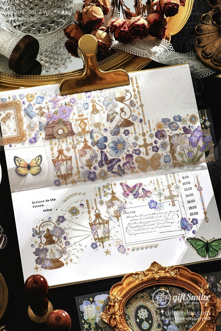 Vintage butterfly and floral themed scrapbook stickers on an open journal, pastel purple and gold aesthetic for craft and stationery lovers.