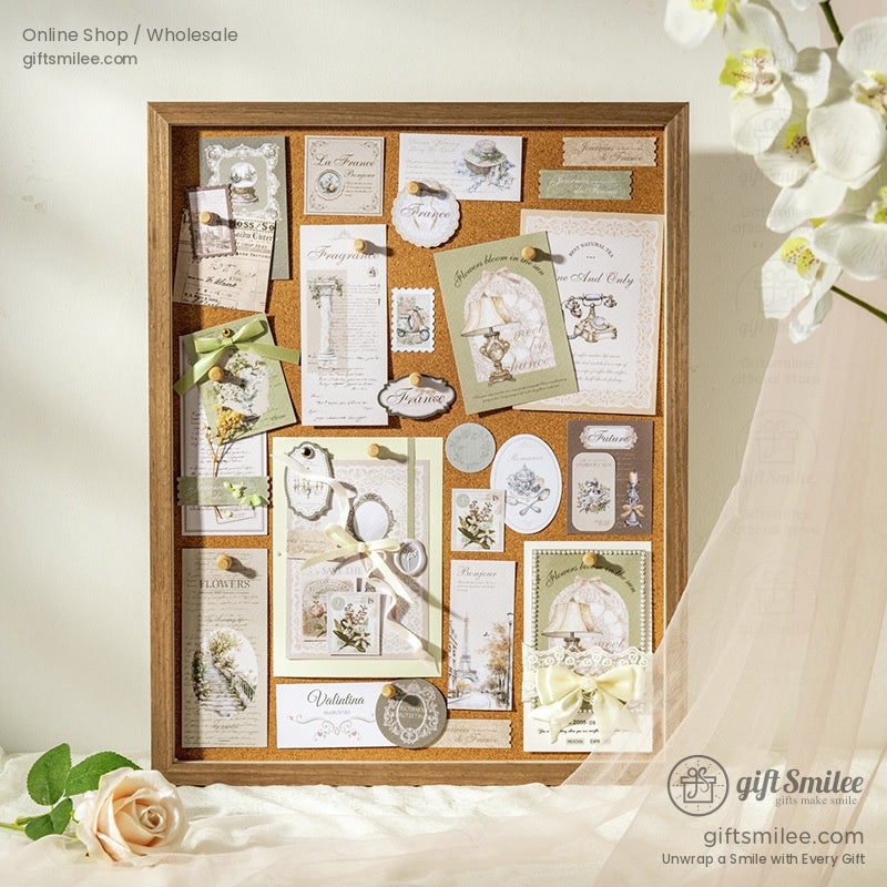 Vintage French-themed stationery set with assorted postcards, labels and tags tied with twine, ideal for scrapbooking and journaling.