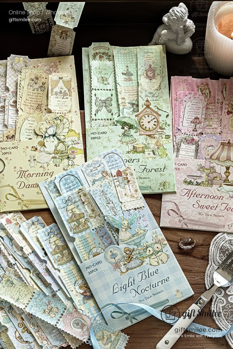 Pastel vintage-style stationery and bookmark sets on a wooden desk, featuring designs like “Morning Dawn,” “Deepers Forest,” “Afternoon Sweet Tea,” and “Light Blue Nocturne.”