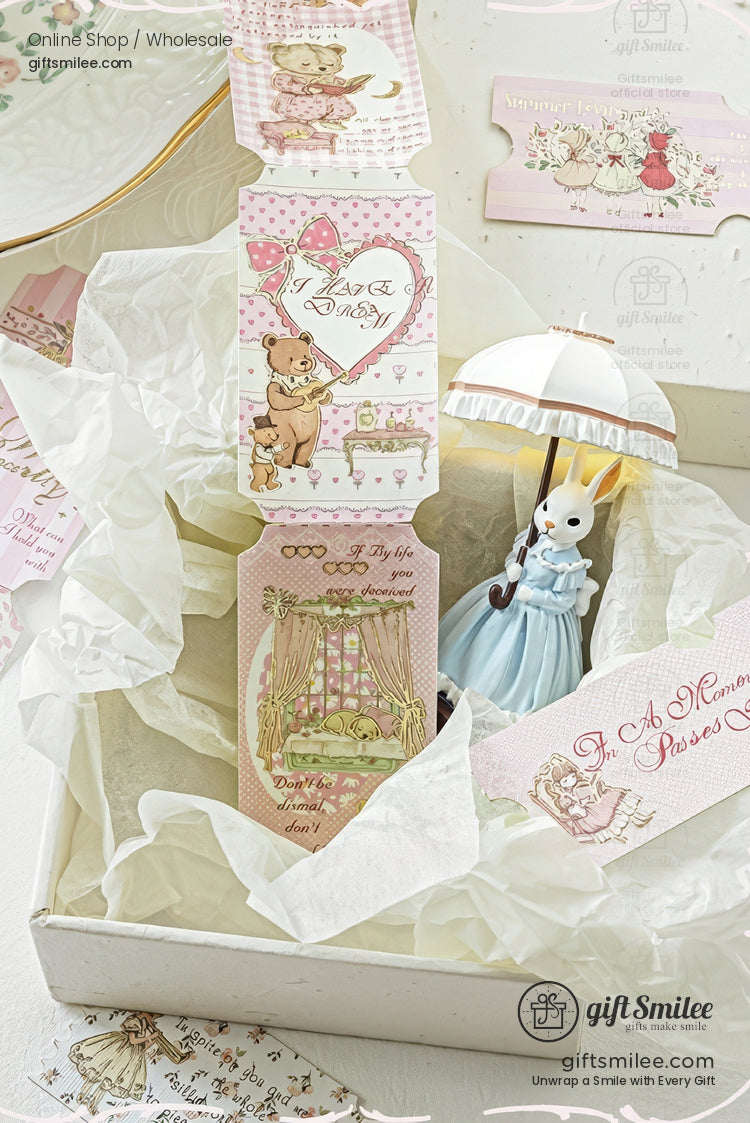 Vintage pastel gift set with kawaii greeting tags and cute rabbit figurine in blue dress holding umbrella, styled in tissue paper box - giftsmilee branding visible.