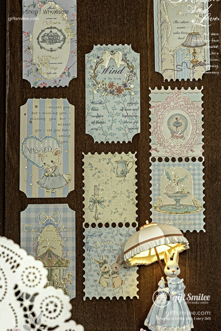 Vintage-style pastel paper stickers with cute animal and floral illustrations displayed on a wooden background, ideal for scrapbooking or journaling.