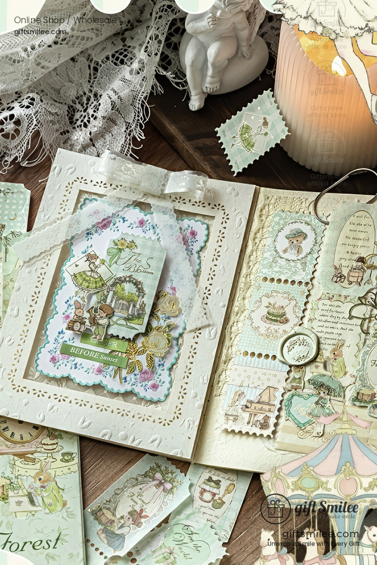 Vintage-inspired scrapbook and stationery set with lace details, pastel illustrations, and decorative paper ephemera on wooden desk for craft journaling.