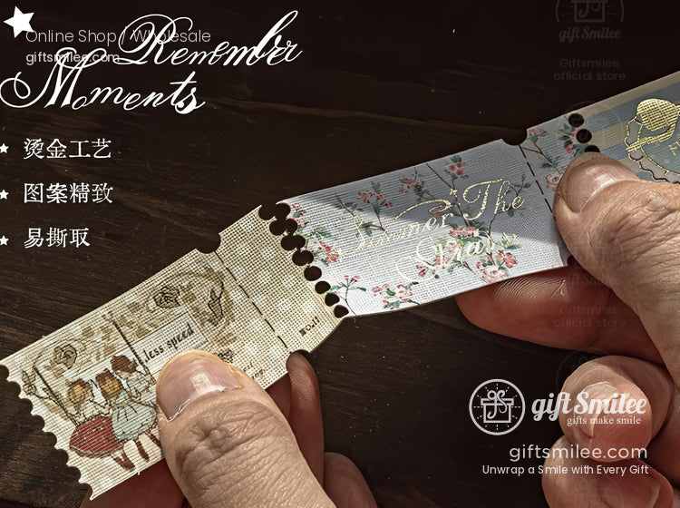Close-up of hands tearing a perforated vintage-style decorative ticket sticker with floral and retro illustrations, branded “giftsmilee” on a wooden background.