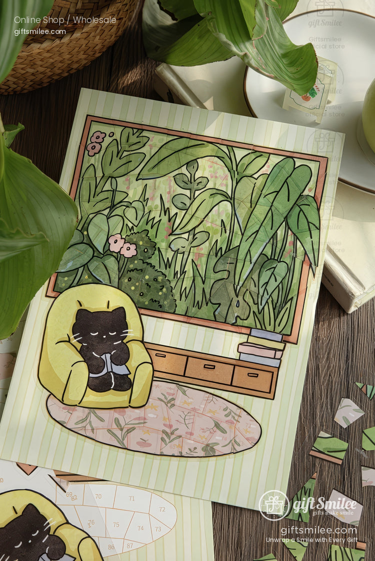 Cozy black cat in yellow armchair art print with houseplant window scene – giftsmile illustration on wooden desk