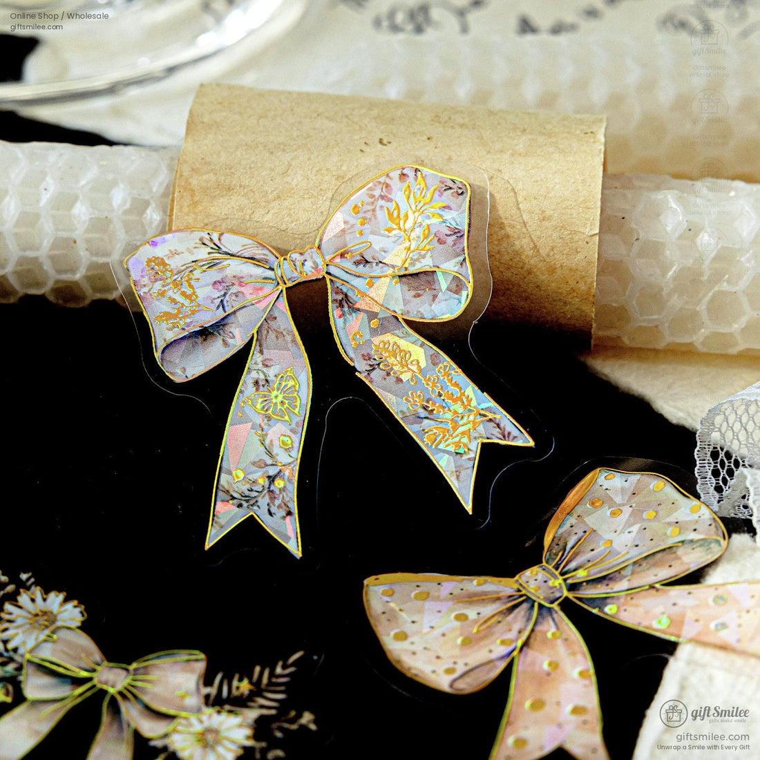 Holographic floral bow sticker with gold foil accents on black background for planners and crafts