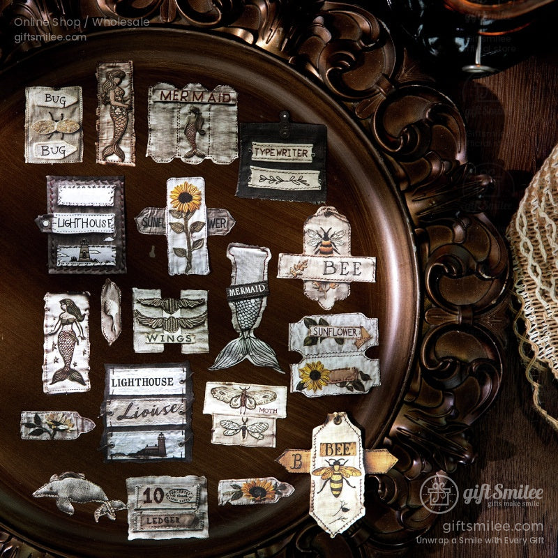 Vintage-style sticker set on ornate tray featuring bees, mermaids, sunflowers, lighthouse, moths, and typewriter labels – scrapbook ephemera by Giftsmilee for journaling and crafts.