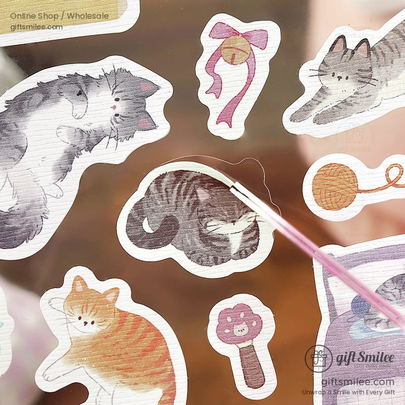 Two sheets of catthemed stickers with pastel backgrounds featuring playful felines plants and cozy household items