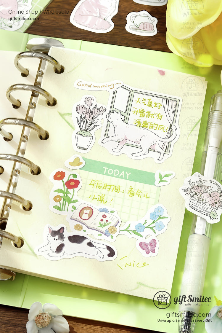 Pastel green planner with whimsical cat and flower stickers pen holder and decorative illustrations
