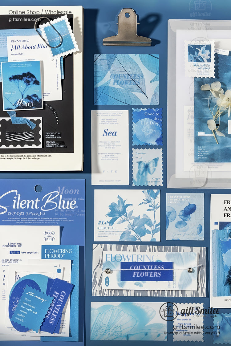 Assorted bluetoned stationery with botanical prints floral patterns and text arranged on a matching blue background