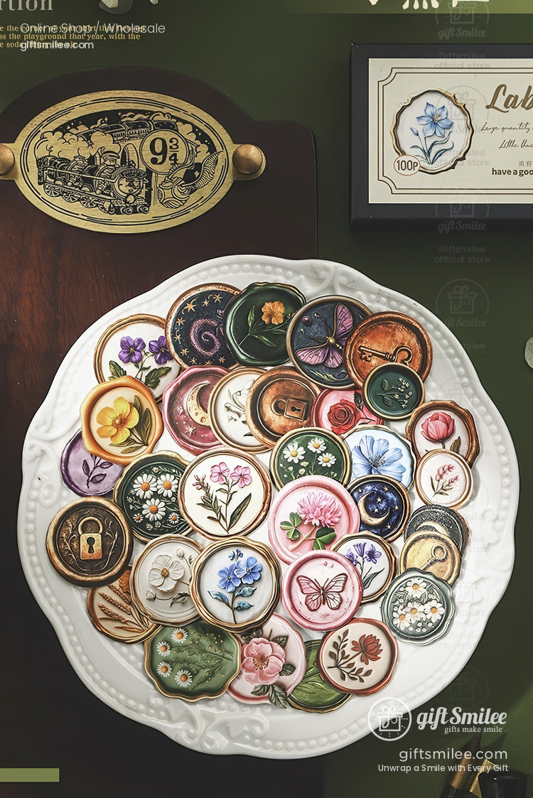 Decorative ceramic magnets in floral butterfly and vintage designs on a white plate against a green backdrop