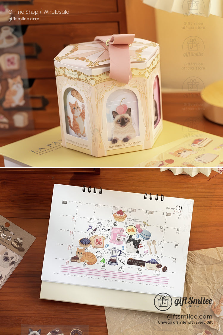 Pasteltoned gift box with cat illustrations pink ribbon and a detailed desk calendar featuring playful feline stickers