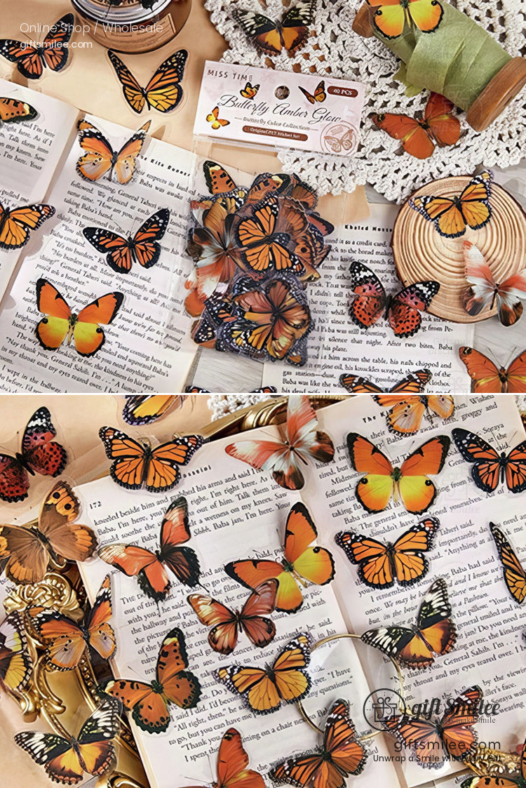 Assorted orange and black butterfly stickers on open books featuring intricate patterns and realistic wing designs