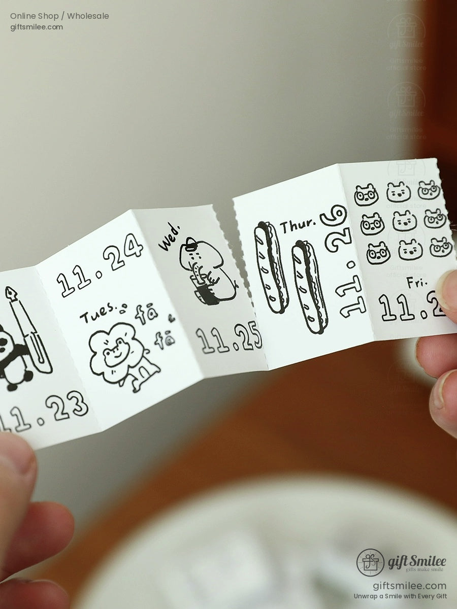 Foldable paper calendar with black doodle illustrations quirky animal designs and bold date numbers in white