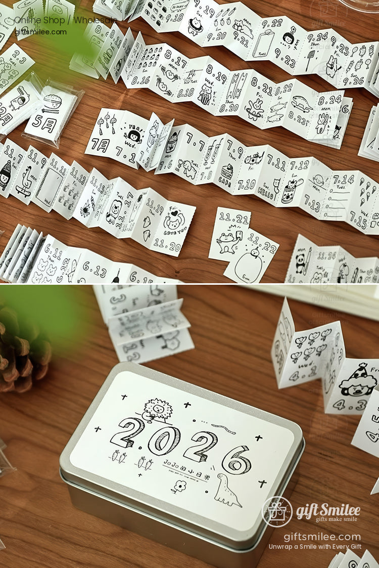 Compact 2026 planner set with black doodle illustrations foldable white paper pages and a silver storage tin box