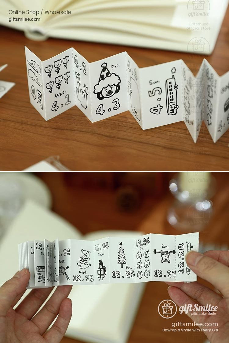 Accordionstyle blackandwhite mini calendar with handdrawn illustrations on white cardstock displayed on a wooden table