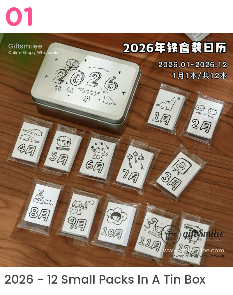 Silver tin box with 2026 text containing 12 monthly cartoonillustrated calendar cards in individual plastic sleeves