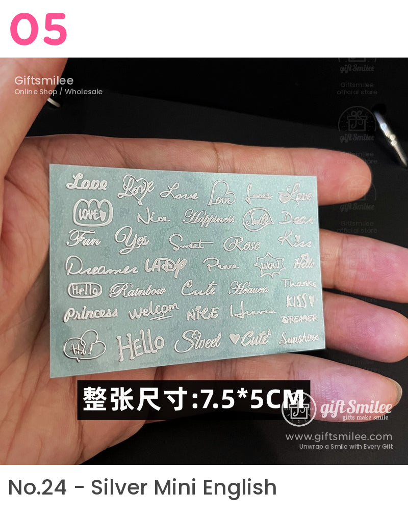 Silver metallic nail art stickers with various engraved words like Love and Cute on a turquoise backing 75x5 cm