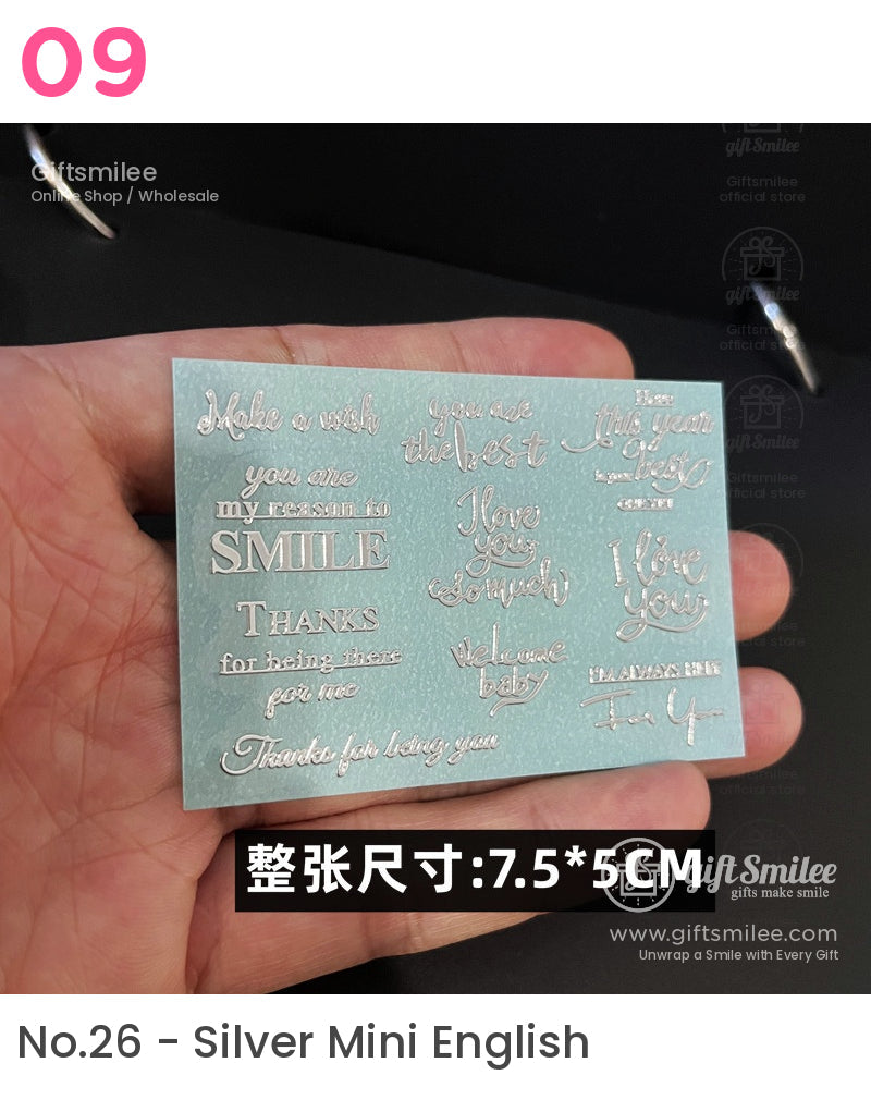 Metallic silver phrase stickers on a light blue textured rectangular sheet featuring decorative fonts and heartfelt messages