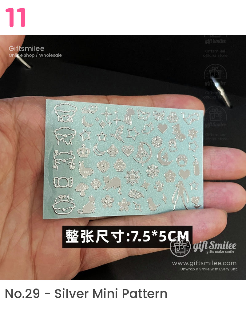 Silver metallic nail art stickers with various designs including stars crowns animals and hearts on a teal background