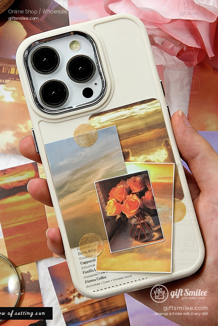 Creamcolored phone case with sunset and floral collage design featuring warm tones and glossy finish