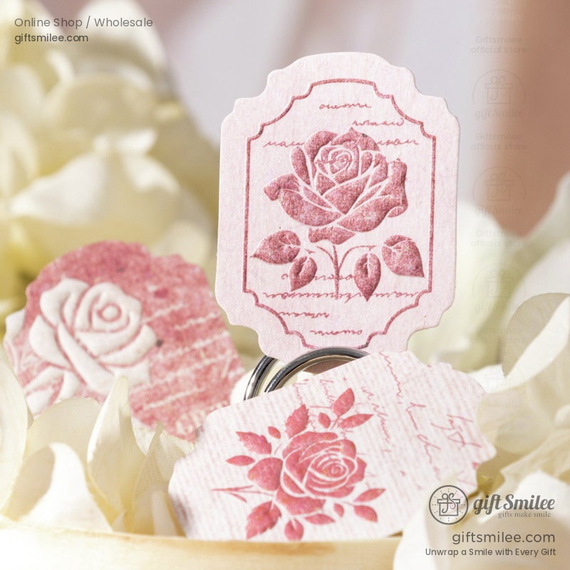 Vintagestyle pink paper tags with detailed rose illustrations scalloped edges and delicate calligraphy accents