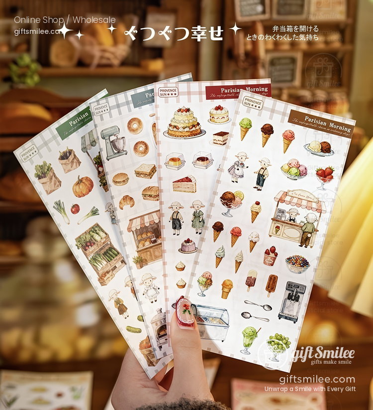 Hand holding bakerythemed sticker sheets with colorful illustrations of cakes pastries bread and vintage decor
