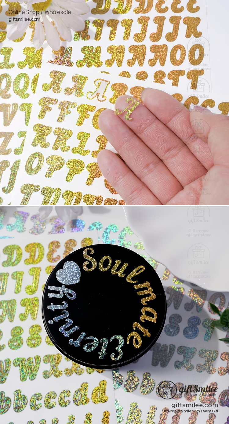 Gold and holographic glitter alphabet stickers with adhesive backing shown on a hand and decorating a black surface