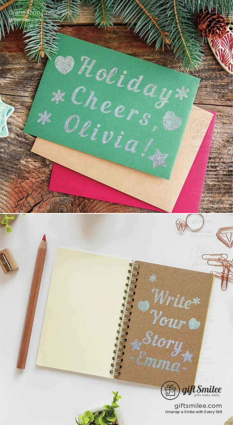 Personalized green holiday card with silver glitter text and stars paired with red and kraft envelopes on a rustic wood table  