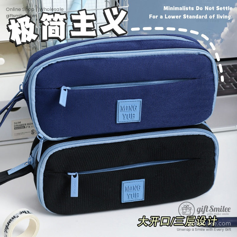 Close-up of the navy blue and black pencil cases with zippers and compartments