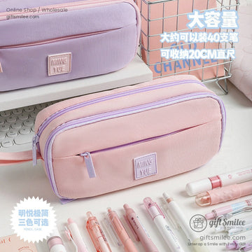 Pink and purple pastel pencil case with large capacity, displayed on a desk with pens