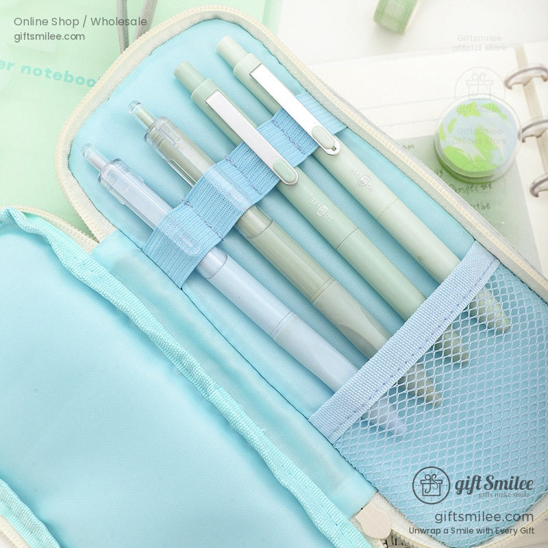 Blue interior of a pencil case holding pastel pens and a mesh pocket for organization