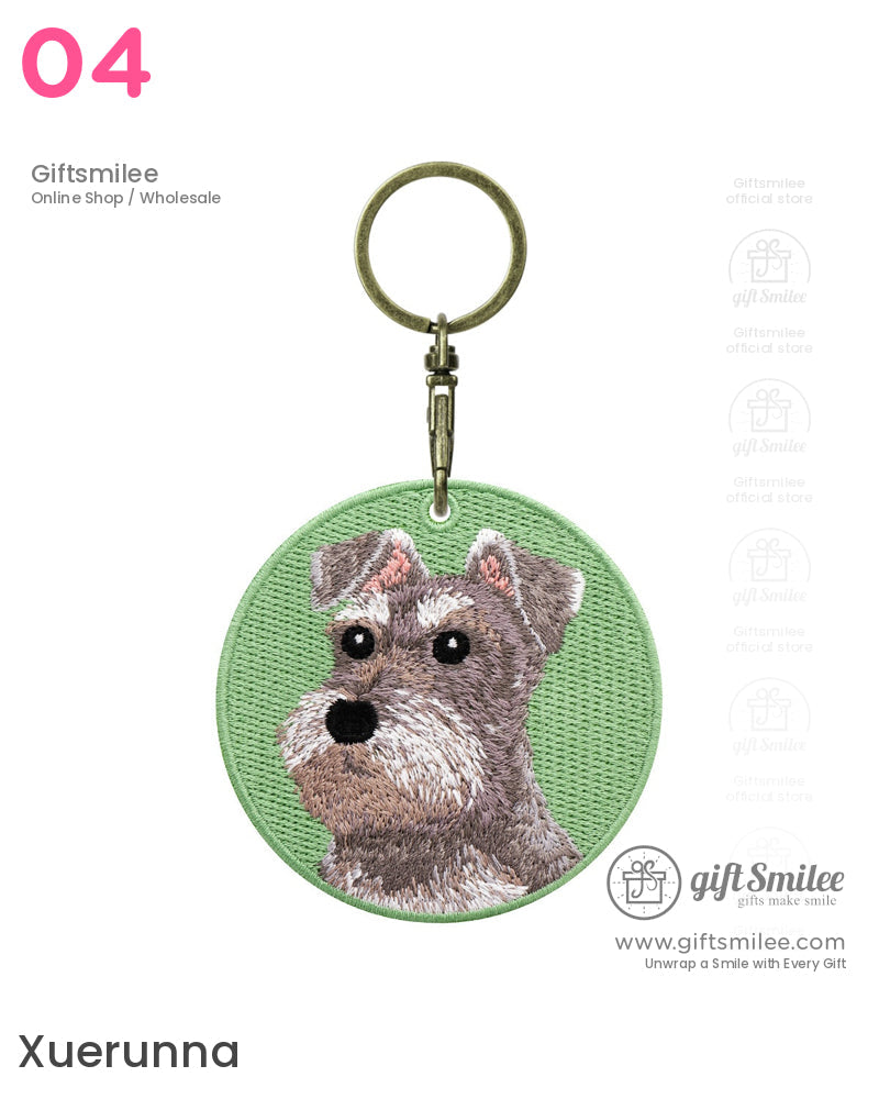 Round green embroidered keychain with a detailed gray Schnauzer dog design and brass metal keyring clasp