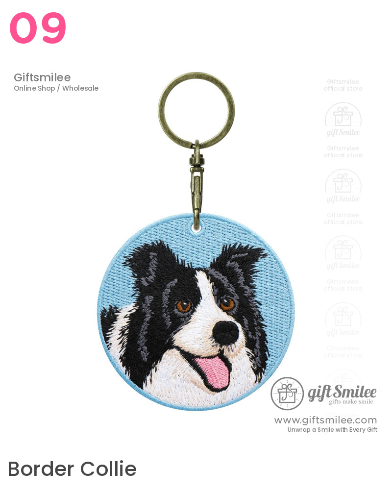Round keychain with embroidered black and white Border Collie on a light blue fabric background antique brass clasp