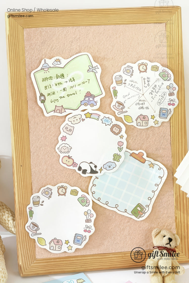 Cute pastel sticky notes with cartoon animal and object borders displayed on a woodenframed corkboard