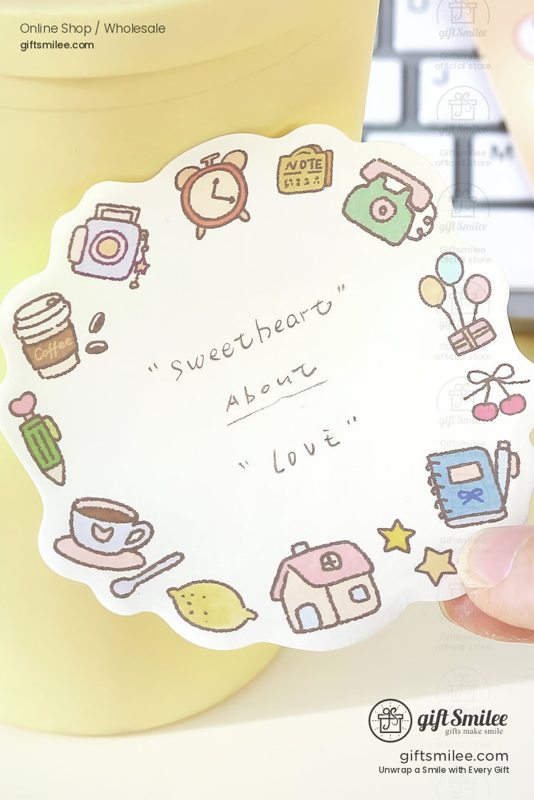 Scalloped white notepad with pastel doodles of a clock camera coffee cup house and sweetheart text