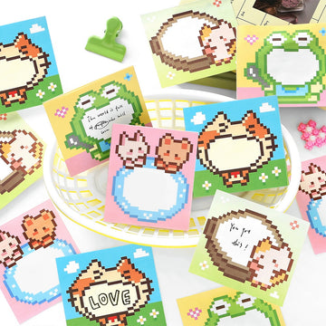 Colorful pixel art sticky notes with animal designs including cats and frogs on pastel backgrounds with blank spaces
